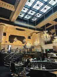 Elegant private wine room in Leeds with chandeliers, perfect for upscale events.