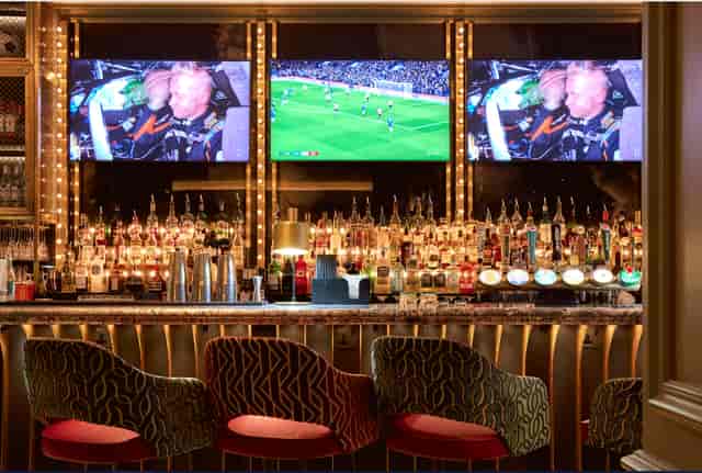 Stylish SOUND Sports Bar with dual screens for networking events and watch parties.