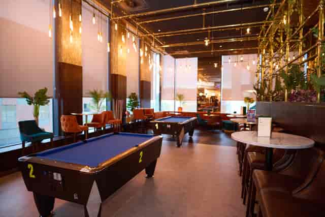 Stylish event space at Newton's Bar, featuring pool tables for casual networking.