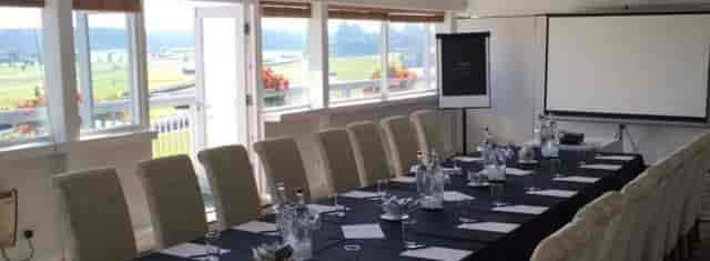 Professional meeting room with natural light at Market Rasen Racecourse for events.