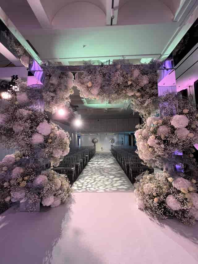 Elegant ballroom at Nobu Hotel with floral arch, perfect for weddings and upscale events.