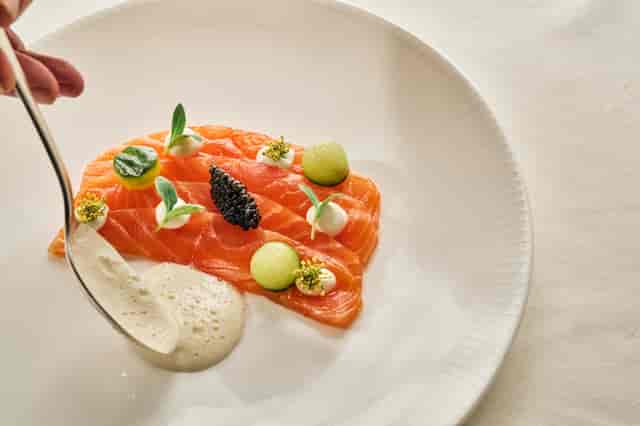 Tower Suite at The Landmark London with gourmet salmon dish for upscale events.