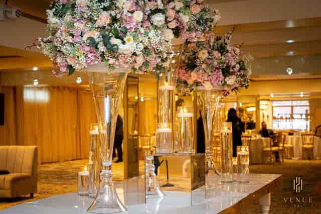 Elegant ballroom with tall floral arrangements, ideal for upscale weddings and events.
