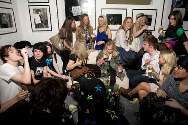 Lively networking event at Proud Galleries with stylish decor and drinks.