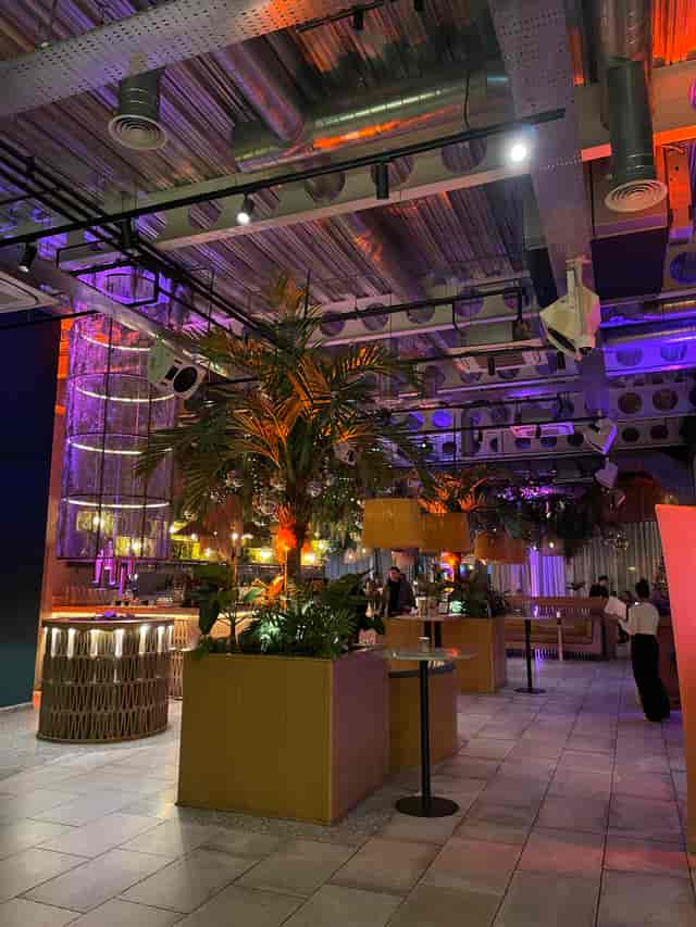 Vibrant event space with lush greenery, perfect for corporate and social gatherings.