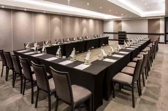 Optima Ballroom meeting room setup with U-shaped tables for professional events.
