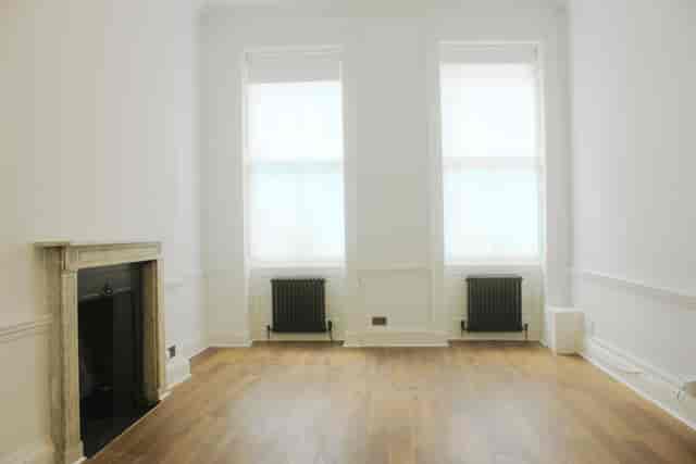 Bright minimalist event space with large windows for workshops and gatherings.