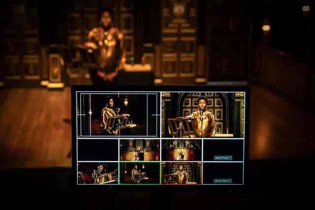 Sam Wanamaker Theatre event setup with speaker, professional lighting, and technology.
