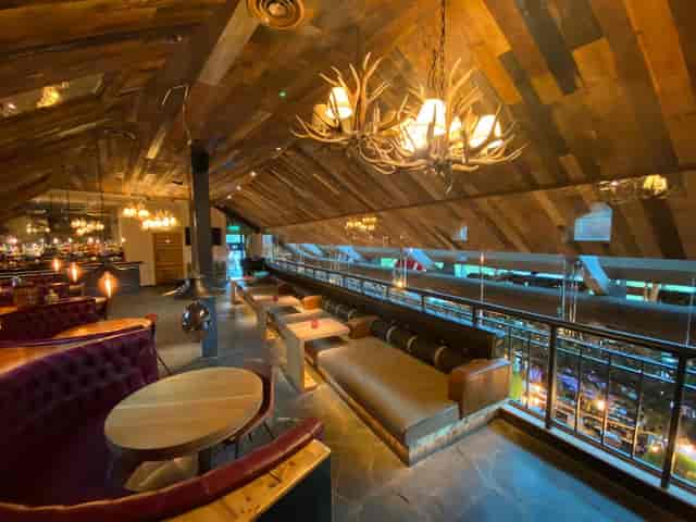 Stylish event space with wooden beams, perfect for networking and intimate gatherings.