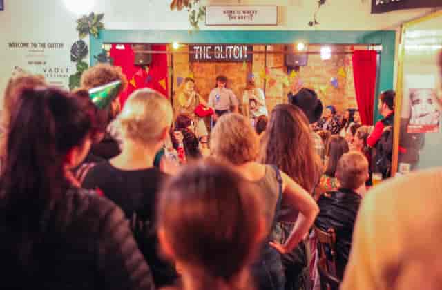 Lively event at The Glitch bar with colorful decor, perfect for networking and workshops.
