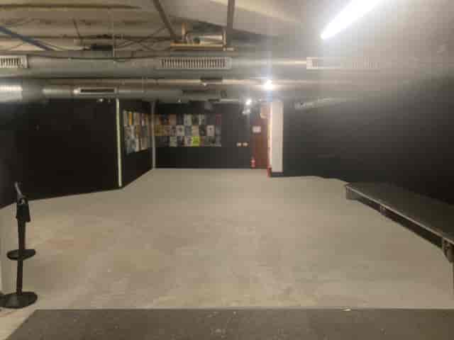 Versatile event space with minimalist design, ideal for presentations and performances.
