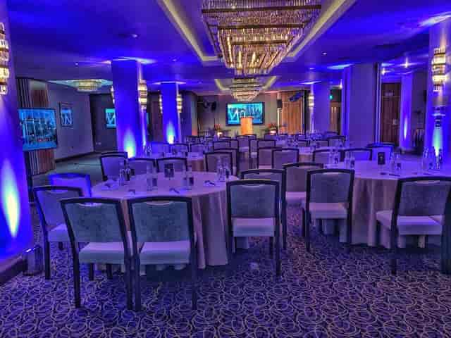 Citi 2 event space with round tables and blue lighting for corporate gatherings.