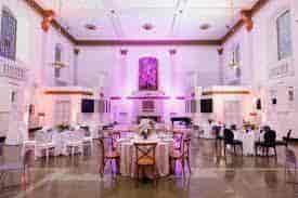 Elegant event space at The Nave, featuring round tables and floral arrangements for weddings.