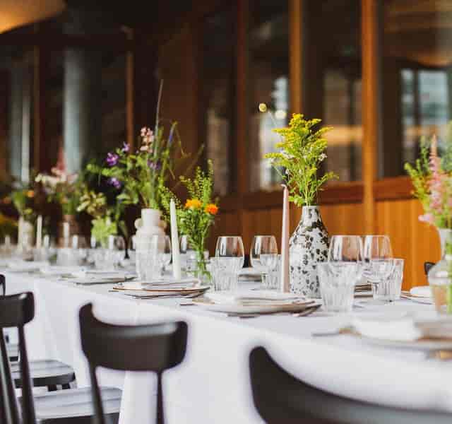 Elegant dining setup with floral centerpieces for corporate events in Dulcie Street Warehouse.