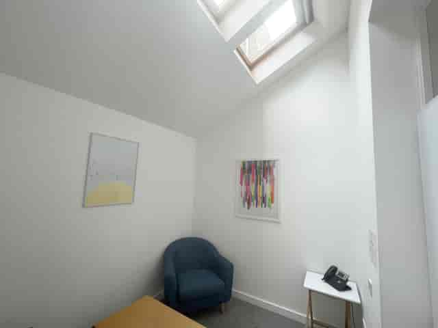 Cozy meeting room with natural light, perfect for intimate discussions and brainstorming.