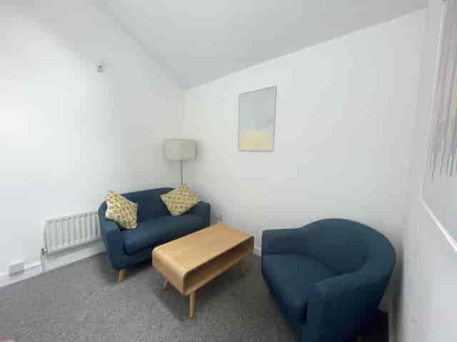Cozy meeting room with soft seating for intimate discussions at Clean Break Studios.