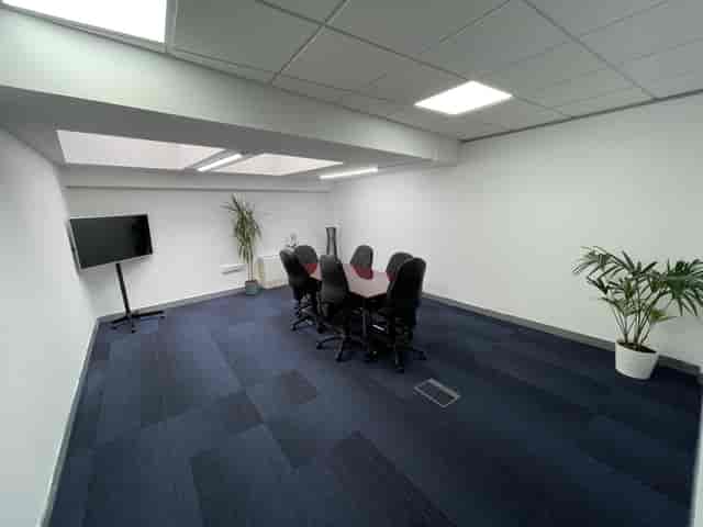 Modern meeting room in Exhibition House with ergonomic chairs for workshops and presentations.