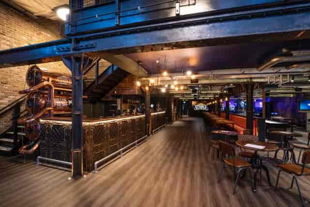 Recording studio event space with exposed brick, ideal for networking and gatherings.