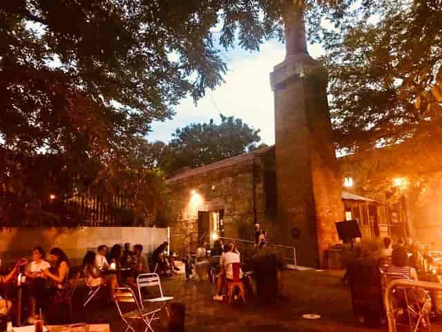 Charming outdoor venue with rustic architecture for summer gatherings and networking events.
