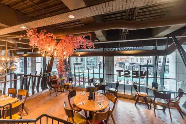Modern dining space at Nest Bishopsgate with cherry blossom decor for events.