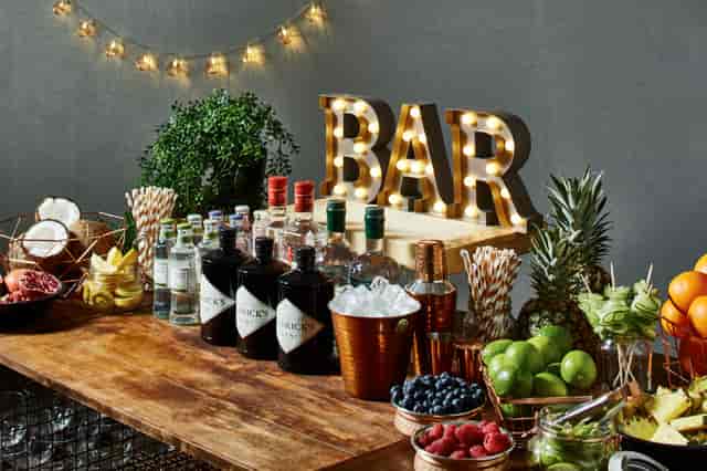 Worsley Suite bar setup with spirits and fruits, ideal for events and networking.