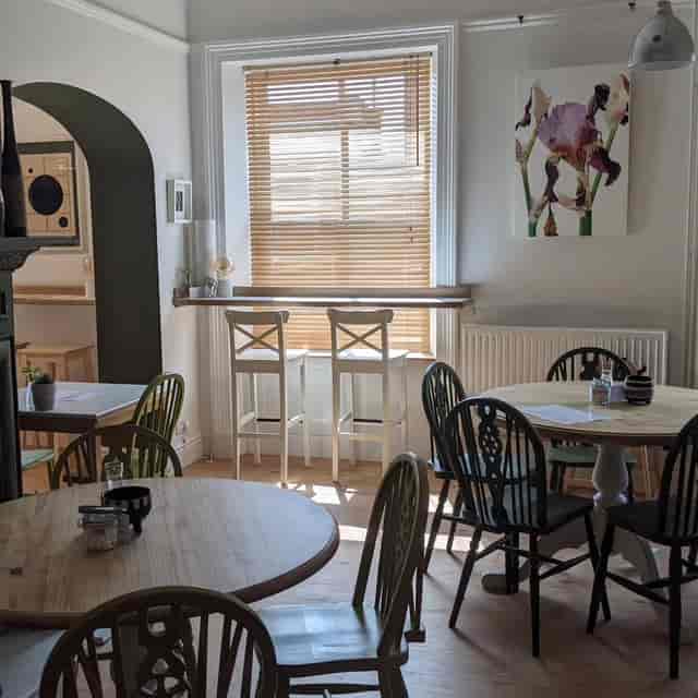 Bright meeting space at The George Cafe with natural light, ideal for gatherings and brainstorming.