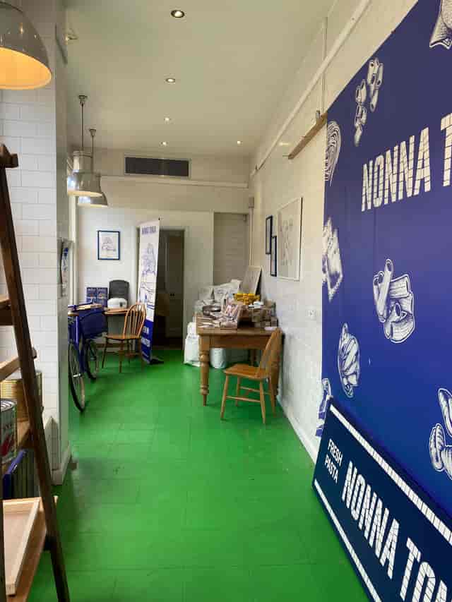 Cozy main room with green flooring, perfect for workshops and networking events.