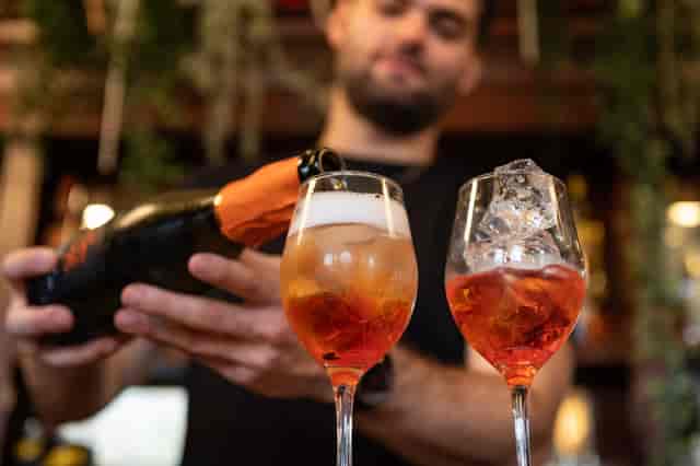 Bartender pouring sparkling drinks at The Bridge, ideal for events and celebrations.