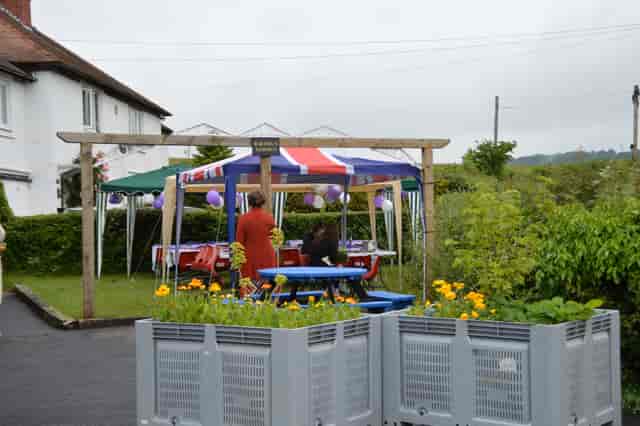 Eastham Memorial Hall outdoor event with colorful Union Jack tents and festive balloons.