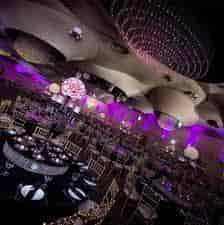 Elegant event space at Pavilion Club with round tables and purple lighting for weddings.