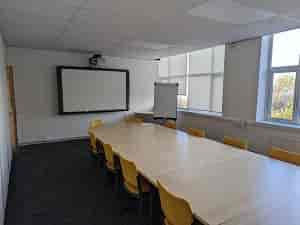 Main Hall in Rethink Rebuild Society, bright meeting room with large table for workshops.