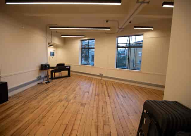 Versatile event space with wooden flooring and natural light for workshops at Musical Theatre College.