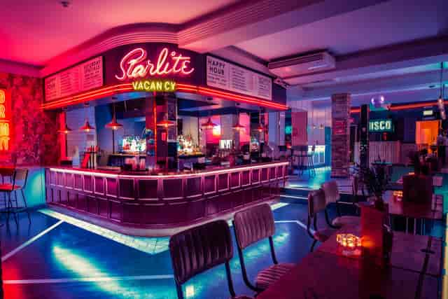 Vibrant Simmons Bar with neon lights, ideal for networking and social events.