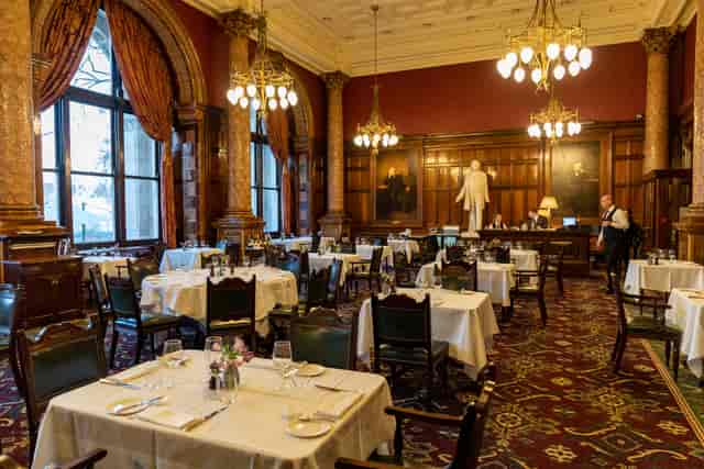 Elegant dining room with white linens, ideal for formal events and upscale gatherings.