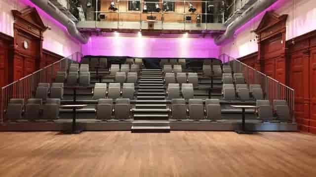 Grote Zaal in De Balie: tiered seating for presentations and performances, modern event space.