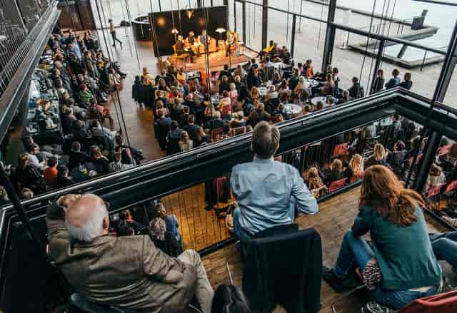 Panel discussion in Royal Danish Theatre's Playhouse Foyer, modern venue, networking event.