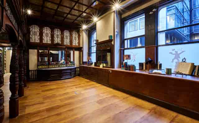 Gladstone Room: elegant wooden event space with natural light for meetings and gatherings.