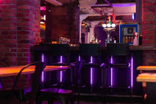 Stylish bar area with modern lighting for networking events and social gatherings.
