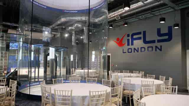 iFLY Indoor Skydiving event space with round tables for corporate gatherings in London.