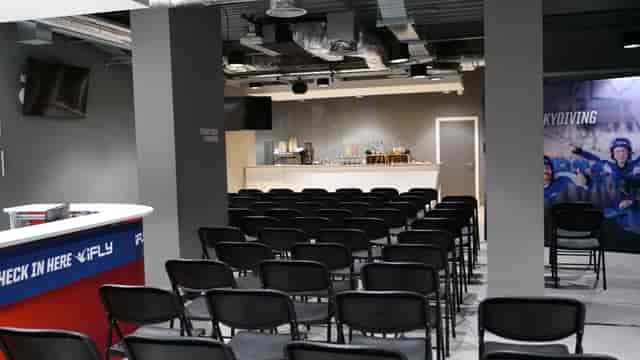 iFLY Indoor Skydiving bar area with black chairs for meetings and events at The O2