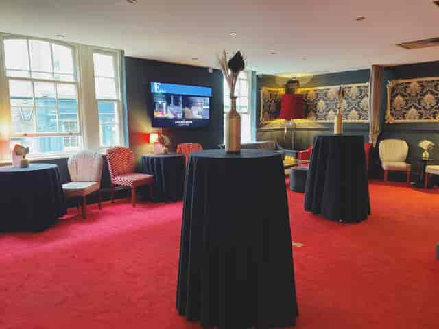 Ambassadors Lounge in ATG VIP, elegant event space with high-top tables for networking events.