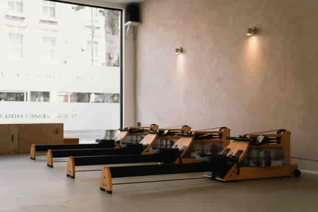 Minimalistic fitness studio with rowers, ideal for wellness events and team-building activities.