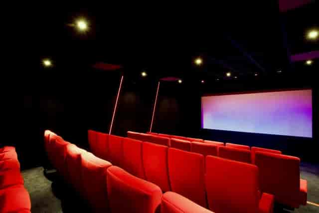 Modern screening room with plush red seating for exclusive film viewings and corporate events.