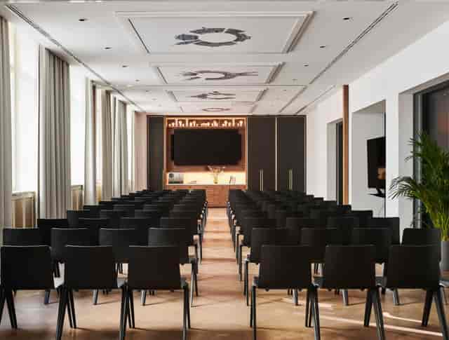 Andaz Studio 1 2 3 in Prague, modern meeting space with sleek black chairs for events.