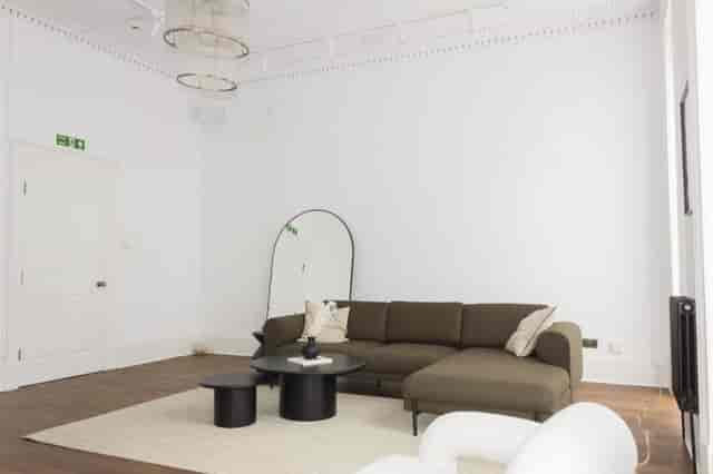 Modern minimalist meeting space with sectional sofa for brainstorming sessions.