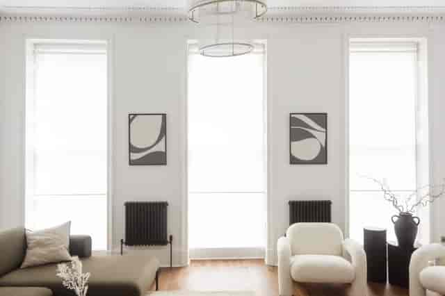 Modern minimalist meeting space with natural light, ideal for creative gatherings.
