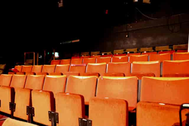Empty theater seats in CYTO's Green Room, ideal for engaging events and meetings.