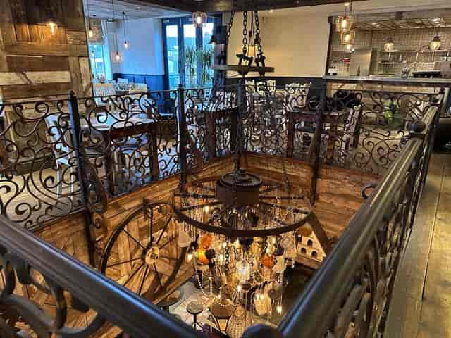 Elegant event space with rustic wood and wrought iron, ideal for gatherings and celebrations.