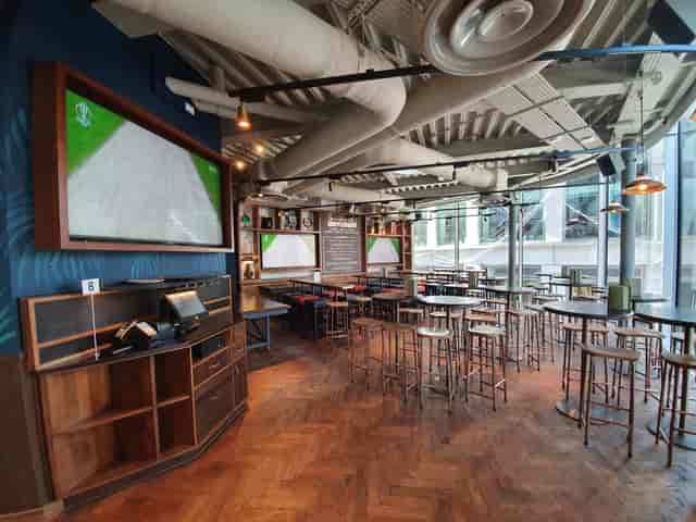 Modern event space in Broadleaf with high-top tables, perfect for networking events.