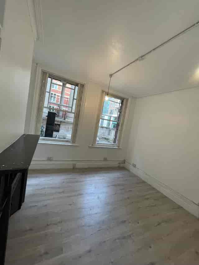 Bright, empty room with large windows for small meetings or workshops at Saras Venue.